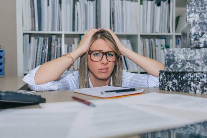 Exhausted Secretary With Lot Of Work In Office