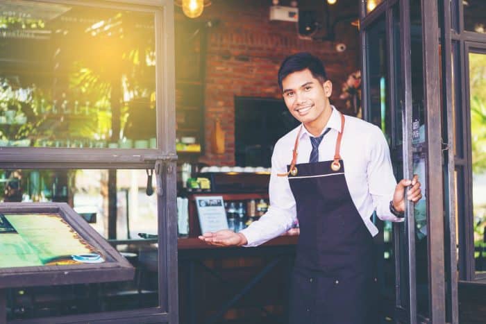 Handsome Man Waiter Open The Door And Warm Welcome To You