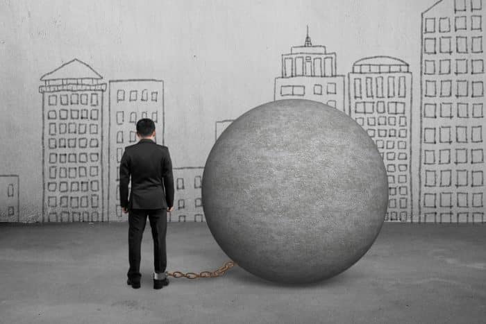 Businessman Being Trapped With Concrete Ball